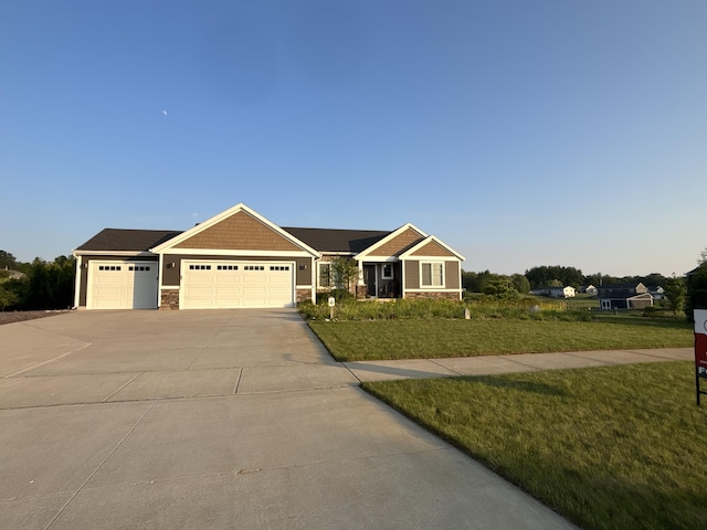 11726 Ridge Water Dr NE, Sparta, MI 49345 - view of front of property featuring a garage, concrete driveway, a front lawn, and stone siding