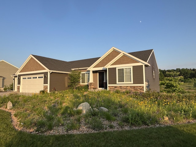 11726 Ridge Water Dr NE, Sparta, MI 49345 - craftsman-style home featuring stone siding, a garage, and driveway