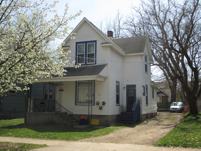 617 Forest St, Kalamazoo, MI 49008 - traditional-style home featuring a chimney, roof with shingles, and dirt driveway