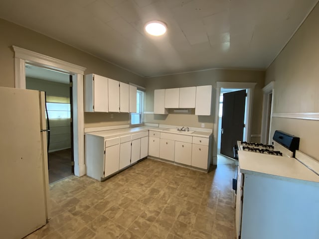617 Forest St, Kalamazoo, MI 49008 - kitchen featuring light countertops, white appliances, a sink, and white cabinetry