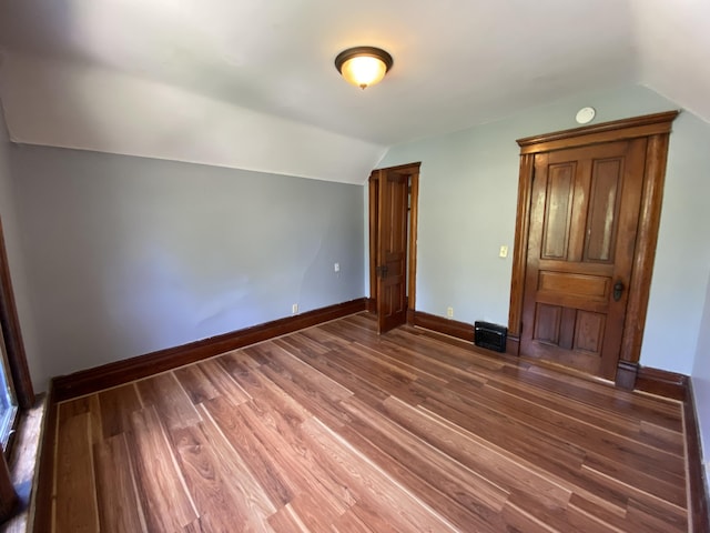 617 Forest St, Kalamazoo, MI 49008 - unfurnished bedroom with lofted ceiling, wood finished floors, and baseboards