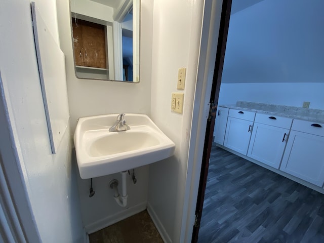 617 Forest St, Kalamazoo, MI 49008 - bathroom with baseboards, wood finished floors, and a sink