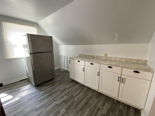 617 Forest St, Kalamazoo, MI 49008 - kitchen with baseboards, lofted ceiling, dark wood-style floors, and freestanding refrigerator