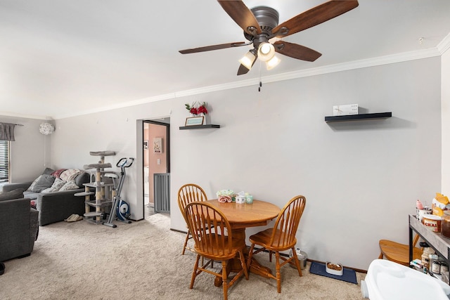 dining room featuring ceiling fan, crown molding, and carpet flooring