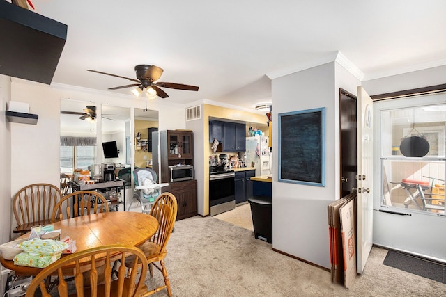 dining room featuring visible vents, crown molding, light colored carpet, and a ceiling fan
