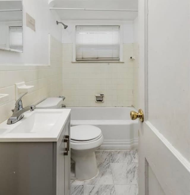 bathroom with shower / bathing tub combination, vanity, toilet, and marble finish floor
