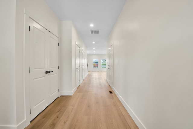 corridor with recessed lighting, visible vents, light wood finished floors, and baseboards