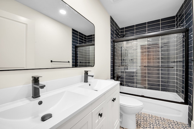 full bath featuring shower / bath combination, double vanity, toilet, and a sink