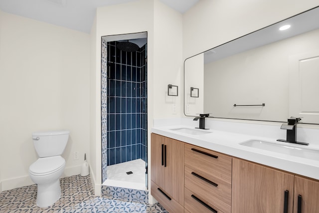 bathroom featuring toilet, a sink, double vanity, and tiled shower