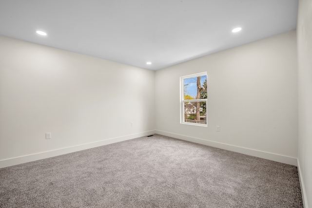 empty room featuring recessed lighting, carpet flooring, and baseboards