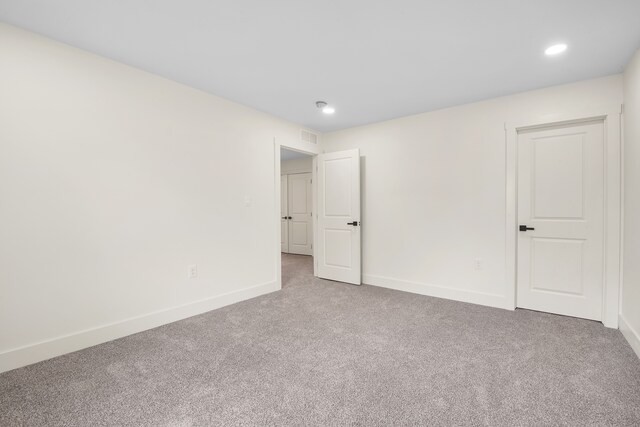 unfurnished bedroom featuring baseboards, visible vents, carpet, and recessed lighting
