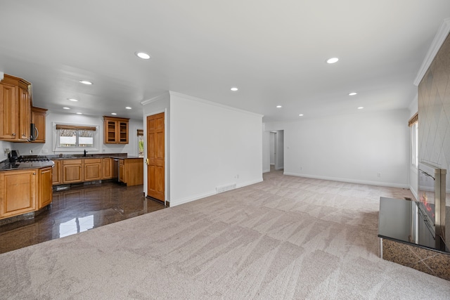 unfurnished living room with recessed lighting, baseboards, visible vents, and a sink