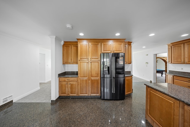 kitchen featuring visible vents, baseboards, stainless steel fridge, recessed lighting, and granite finish floor