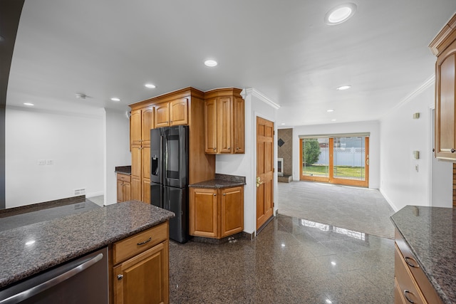 kitchen featuring stainless steel dishwasher, granite finish floor, baseboards, black refrigerator with ice dispenser, and recessed lighting