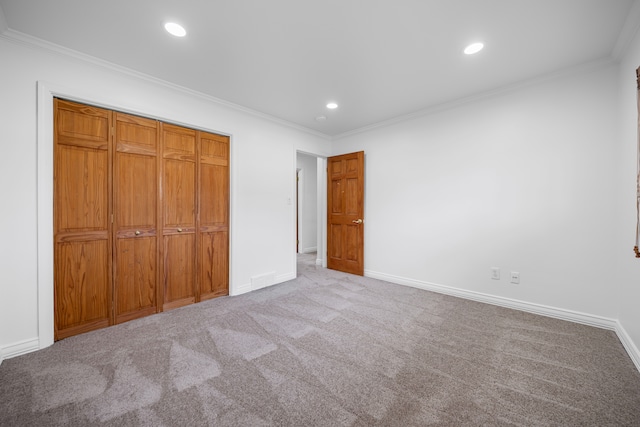 unfurnished bedroom featuring crown molding, baseboards, carpet, and recessed lighting