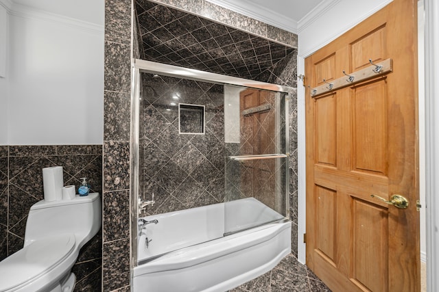 bathroom featuring ornamental molding, combined bath / shower with glass door, toilet, and tile walls