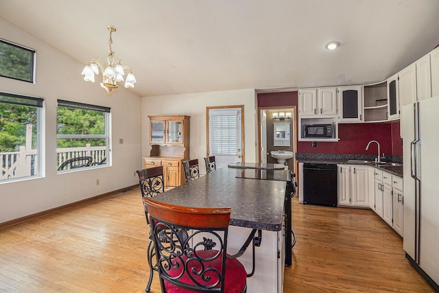 kitchen featuring dark countertops, open shelves, a sink, white cabinets, and black appliances