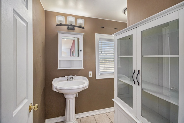 bathroom with baseboards and tile patterned floors