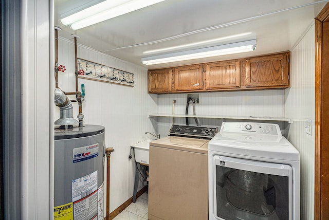 clothes washing area featuring independent washer and dryer, a sink, cabinet space, water heater, and light tile patterned floors