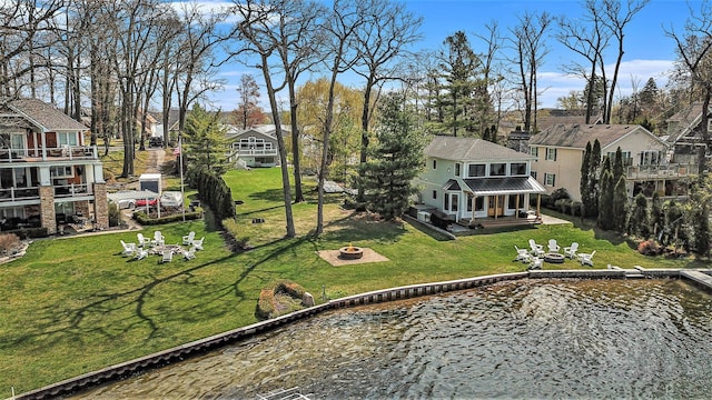 birds eye view of property with a water view and a residential view
