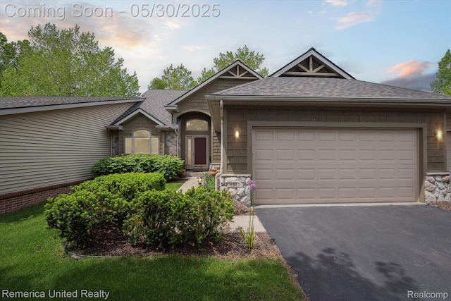1317 Peppergrove Dr, Brighton, MI 48116 - view of front of property featuring stone siding, roof with shingles, asphalt driveway, and an attached garage