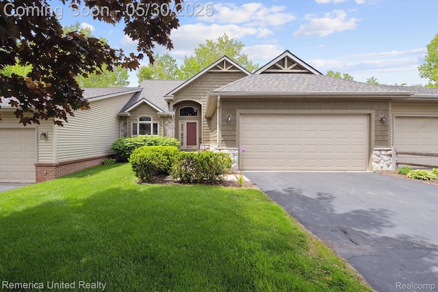 1317 Peppergrove Dr, Brighton, MI 48116 - view of front of home featuring stone siding, asphalt driveway, a front yard, a shingled roof, and a garage