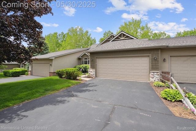 1317 Peppergrove Dr, Brighton, MI 48116 - view of front of property featuring stone siding, asphalt driveway, an attached garage, and a front lawn