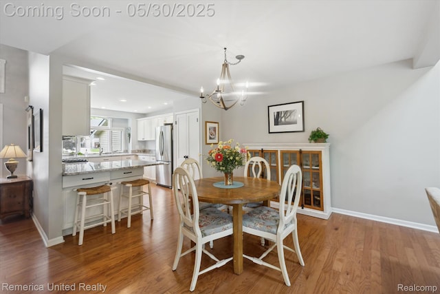 1317 Peppergrove Dr, Brighton, MI 48116 - dining room with a chandelier, light wood finished floors, baseboards, and recessed lighting