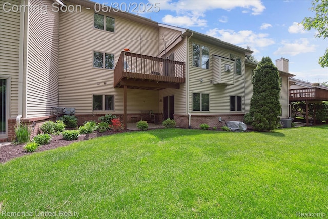 1317 Peppergrove Dr, Brighton, MI 48116 - back of house featuring a lawn and a wooden deck