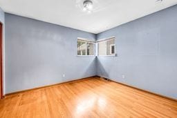 unfurnished room with wood finished floors
