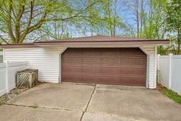 detached garage featuring fence