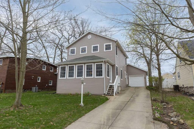 traditional-style home featuring central AC, a garage, an outbuilding, entry steps, and a front yard