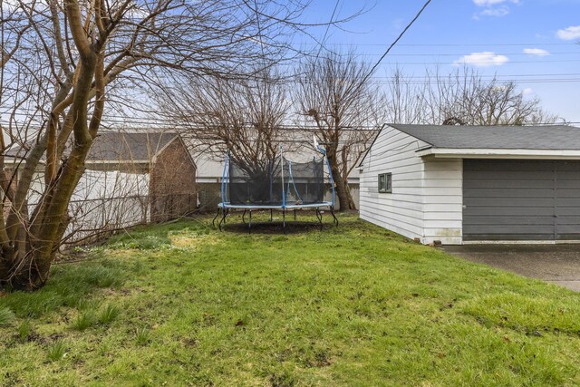 8450 Warren Blvd, Center Line, MI 48015 - view of yard featuring a trampoline and fence