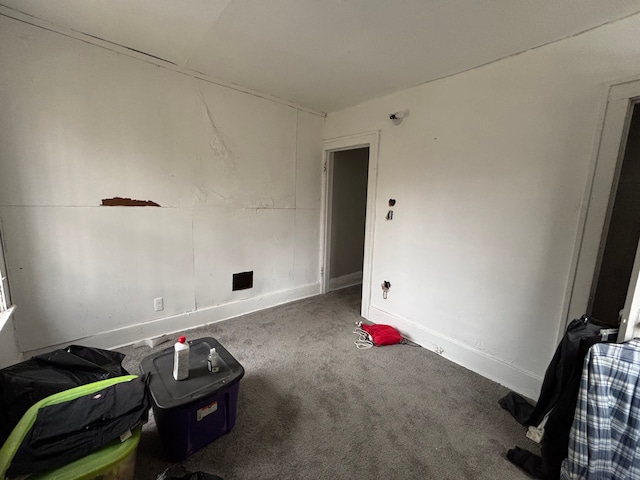 spare room featuring baseboards and carpet floors