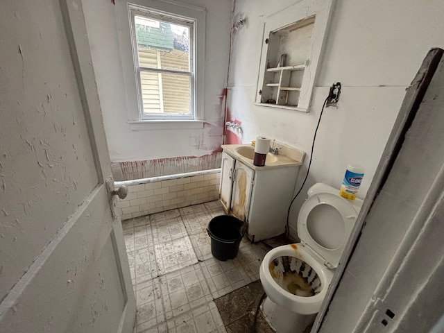 bathroom with toilet, vanity, and tile patterned floors
