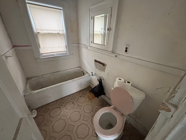bathroom with toilet and a tub