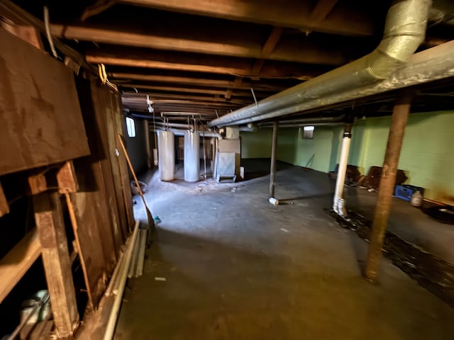 unfinished basement with heating unit and gas water heater