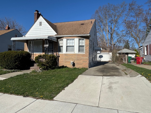 22051 Firwood Ave, Eastpointe, MI 48021 - bungalow-style house featuring stone siding, a shingled roof, a chimney, and a front lawn