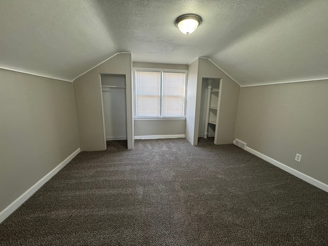 22051 Firwood Ave, Eastpointe, MI 48021 - additional living space with vaulted ceiling, a textured ceiling, visible vents, and baseboards