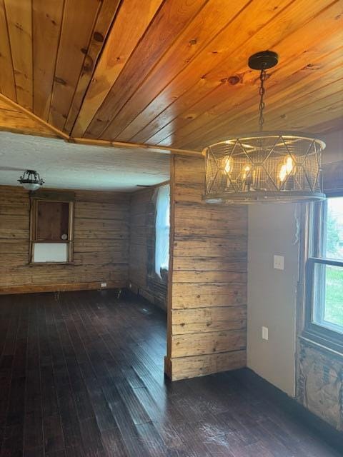 314 W Main, Whitehall, MI 49461 - unfurnished room featuring dark wood-style flooring, wood walls, wood ceiling, and an inviting chandelier