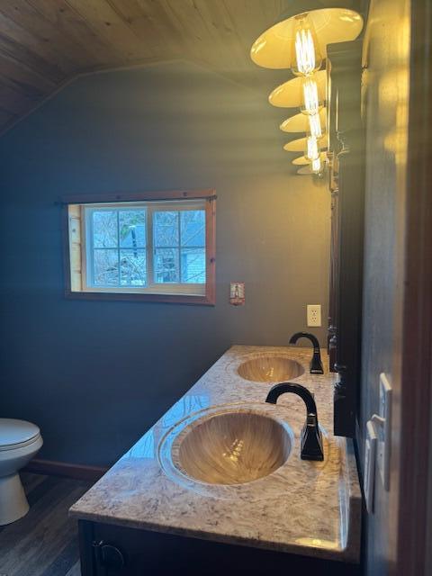 314 W Main, Whitehall, MI 49461 - bathroom featuring lofted ceiling, wooden ceiling, toilet, vanity, and wood finished floors