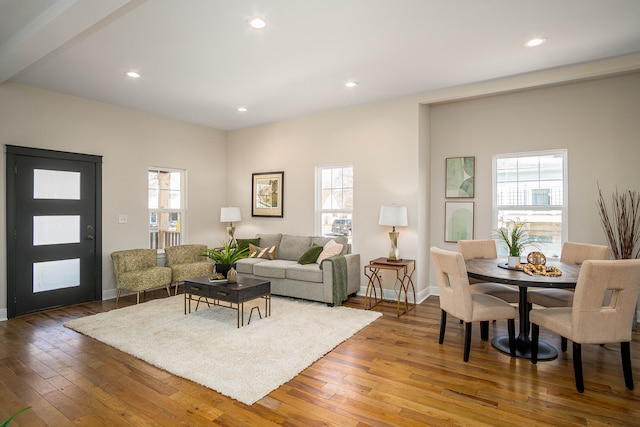 living room featuring healthy amount of natural light, wood-type flooring, recessed lighting, and baseboards