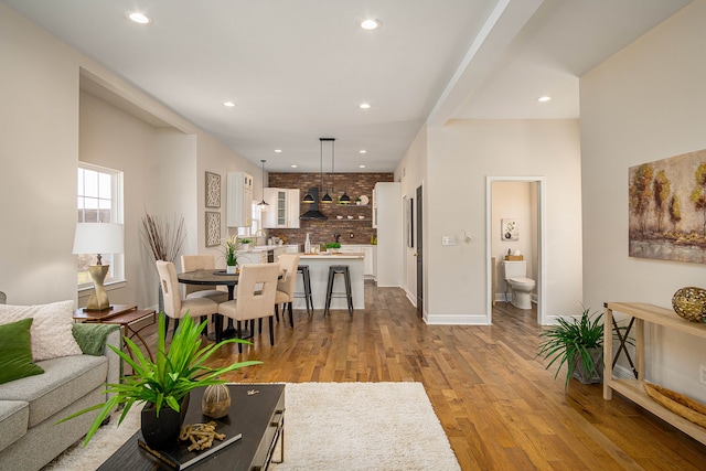 living area featuring wood finished floors, recessed lighting, and baseboards
