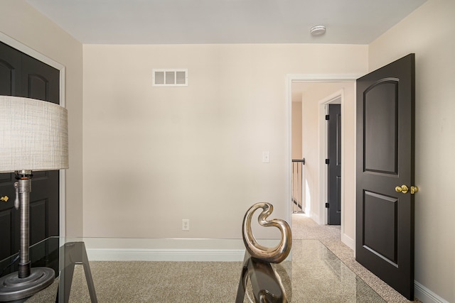 carpeted living room featuring baseboards