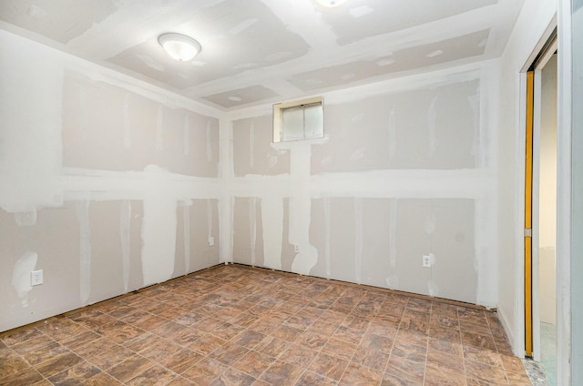 unfurnished room with stone finish floor