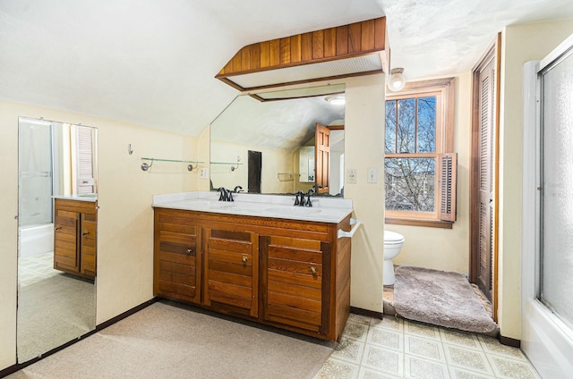 full bath featuring double vanity, an enclosed shower, toilet, a sink, and baseboards