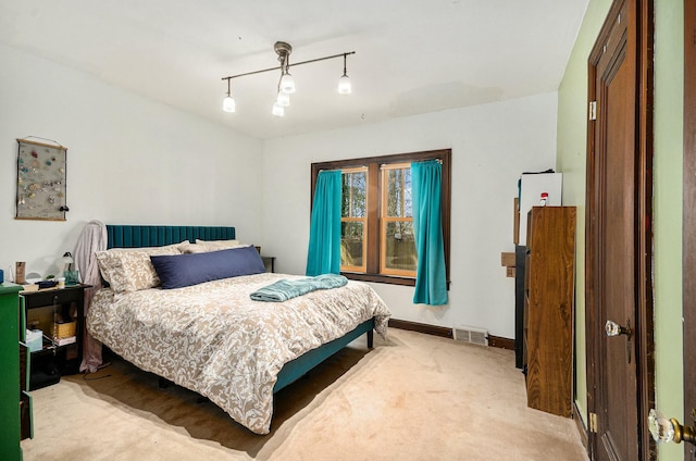 carpeted bedroom with baseboards and visible vents