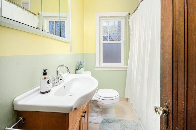 full bath with curtained shower, vanity, tile patterned flooring, and toilet