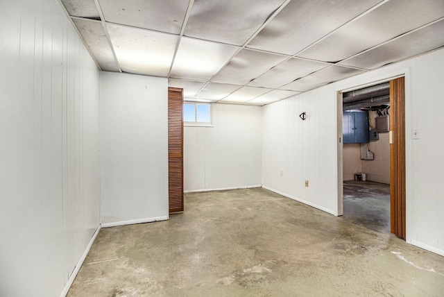 below grade area with baseboards and wood walls