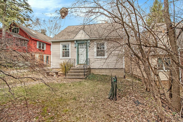 view of front of property with entry steps and roof with shingles